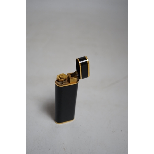 410 - Cartier, black enamel and gold plated lighter