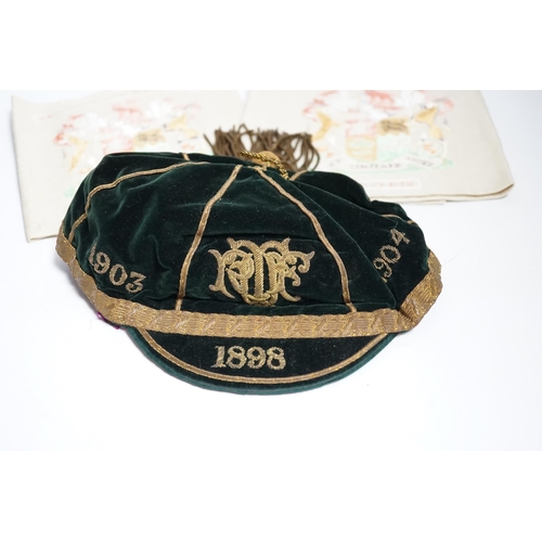 426 - Two South African late 19th century damask railway napkins and a velvet rugby or cricketing cap... 