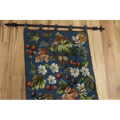 453 - A 20th century woolworked hanging, leaves and flowers, monogrammed and dated