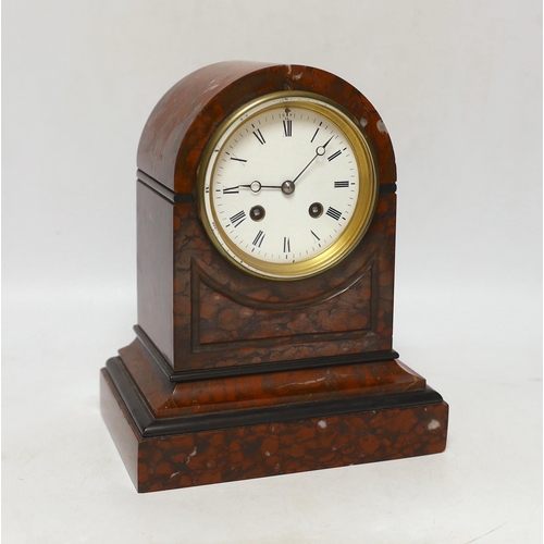 457 - A late 19th century French rouge marble mantel clock, striking on a bell, with key,  24cm high... 