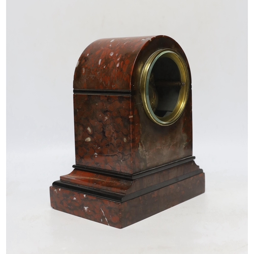 457 - A late 19th century French rouge marble mantel clock, striking on a bell, with key,  24cm high... 