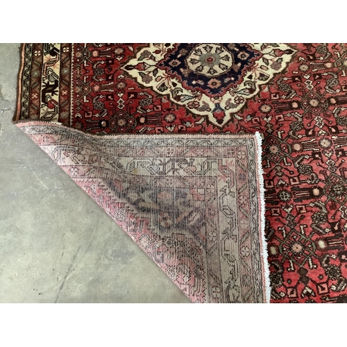 49 - A North West Persian red ground rug, 206 x 141cm