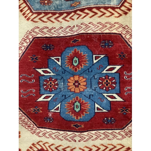 66 - A Caucasian style fawn ground rug, 200 x 132cm