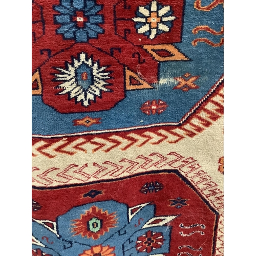 66 - A Caucasian style fawn ground rug, 200 x 132cm