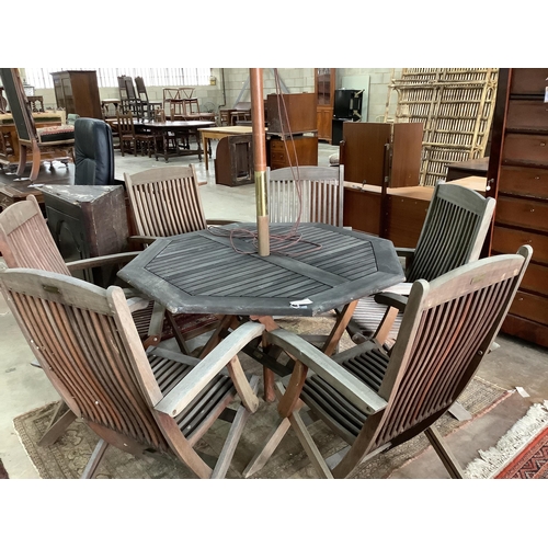 81 - A weathered teak octagonal garden table, width 112cm, height 72cm together with six Beaufort weather... 