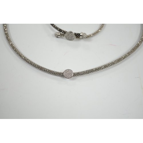 957 - A modern Links of London, silver necklace with diamond cluster motif and a similar bracelet, in Link... 