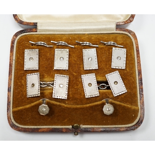 973 - A cased George V engine turned silver and paste set eight piece dress stud set, Henry Griffith & Son... 