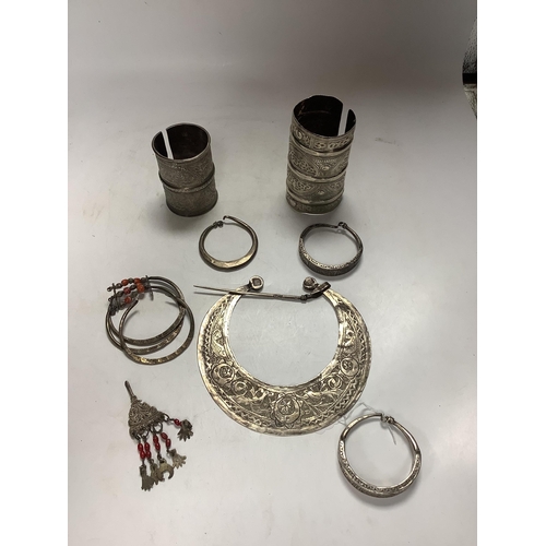 974 - A collection of eight North African Berber white metal jewellery, etc, including bangles, cuffs and ... 