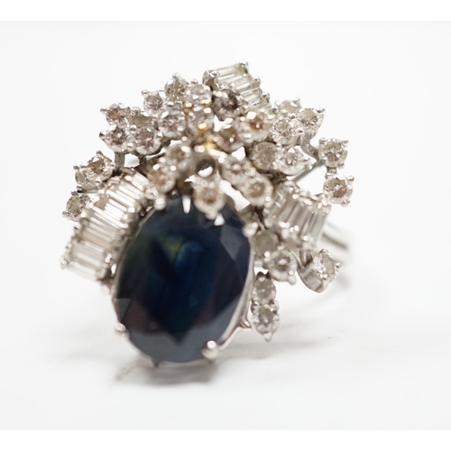 978 - A mid to late 20th century 18k white metal, single stone oval cut sapphire and baguette and round cu... 