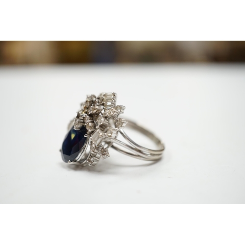 978 - A mid to late 20th century 18k white metal, single stone oval cut sapphire and baguette and round cu... 