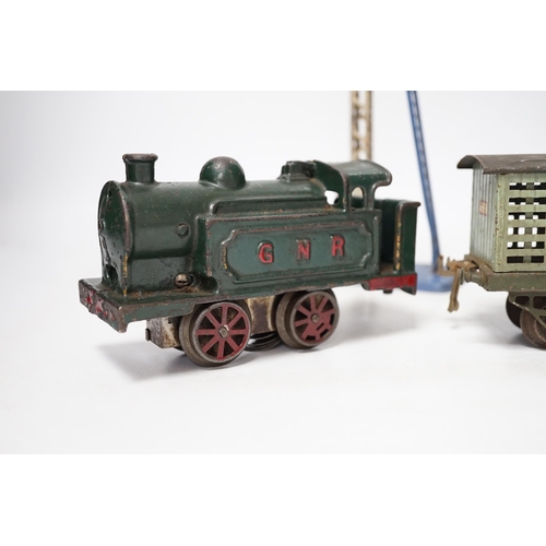 1266 - A collection of O gauge clockwork tinplate model railway, including a cast iron clockwork, GNR, 0-4-... 