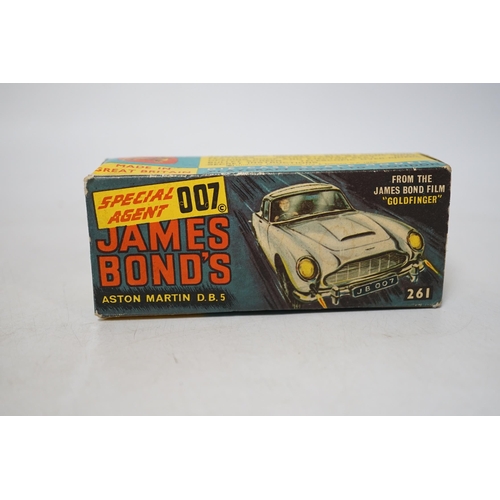 1306 - Corgi Toys James Bond's Aston Martin (261) in gold, boxed with driver, passenger, inner display tray... 