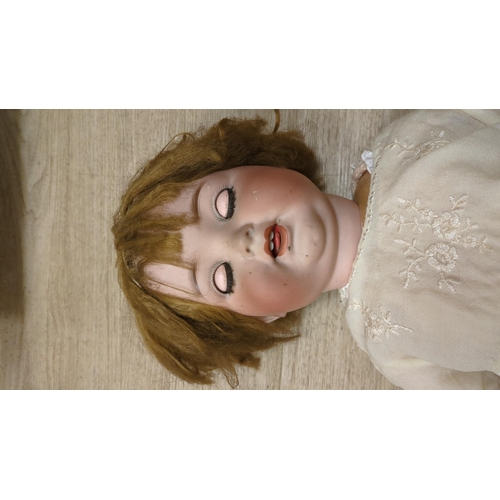 1331 - A Cuno Otto Dressel doll, bent limb, body overpainted, fingers missing on left hand, 56cm