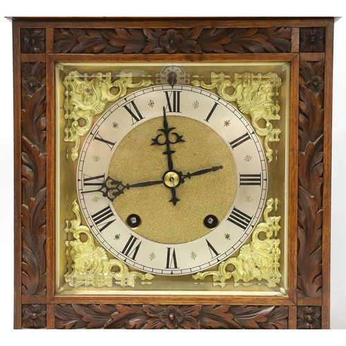 1382 - A carved walnut mantel clock with German movement, 36cm