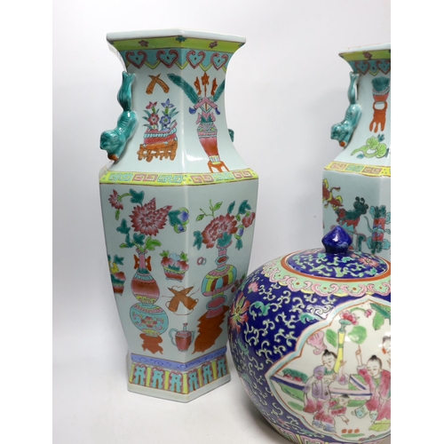 1383 - A pair of Chinese famille rose vases and a similar jar and cover, 38cm