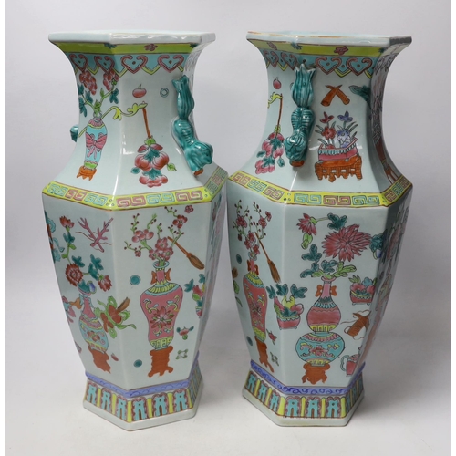 1383 - A pair of Chinese famille rose vases and a similar jar and cover, 38cm