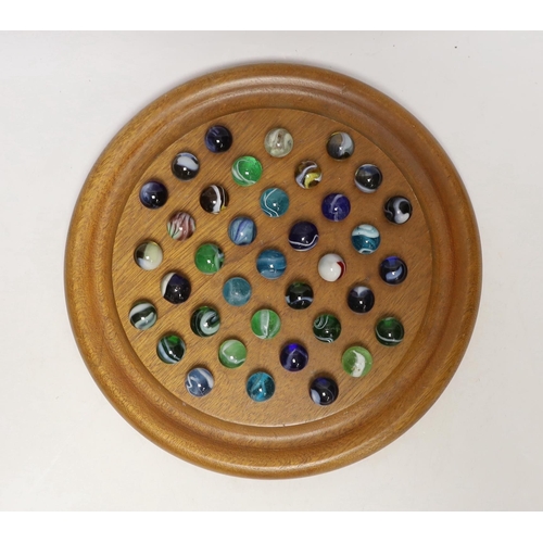 1406 - A solitaire board with glass marbles, board 25cm in diameter