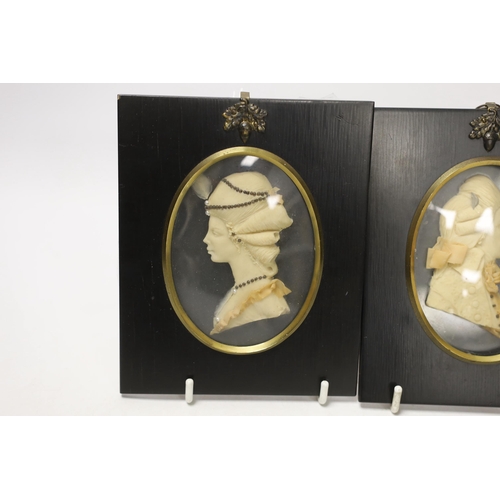 1411 - Attributed to Leslie Ray, pair of 20th century wax relief portraits of  a lady and gentleman wearing... 