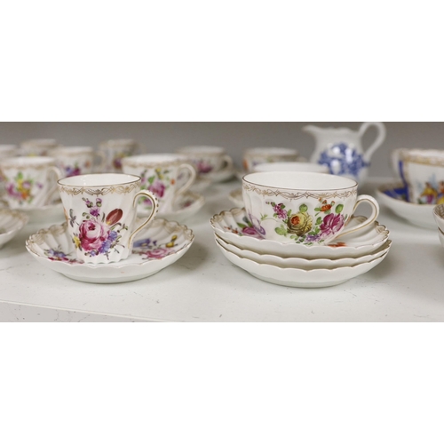 1413 - A group of porcelain Dresden tableware including cups and saucers and a blue and white jug