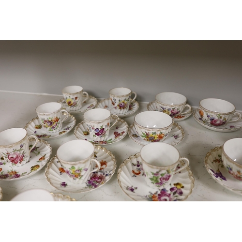 1413 - A group of porcelain Dresden tableware including cups and saucers and a blue and white jug