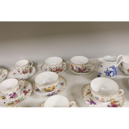 1413 - A group of porcelain Dresden tableware including cups and saucers and a blue and white jug