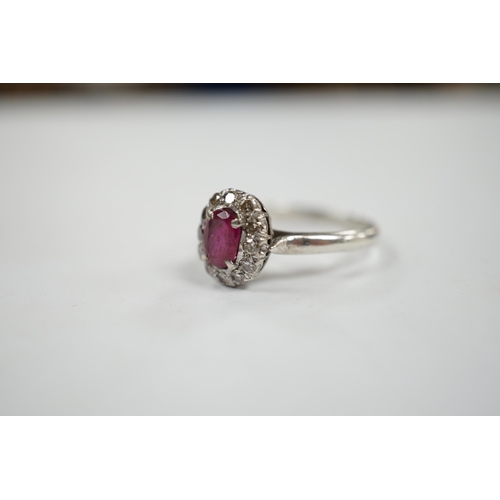 1934 - A white metal, synthetic? ruby and diamond set oval cluster ring, size P, gross weight 3.3 grams.... 