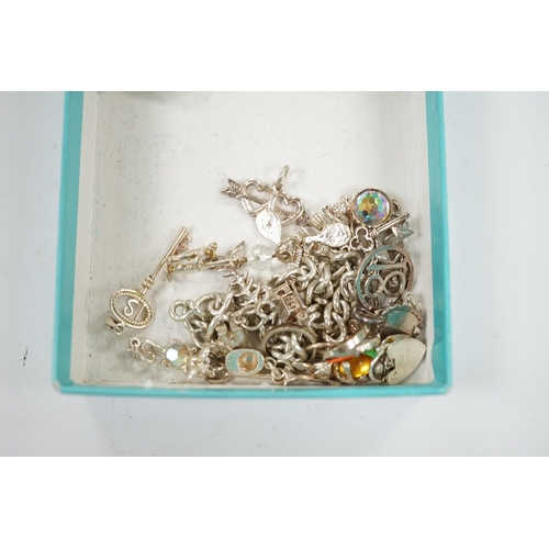 1936 - A 1970's silver charm bracelet, hung with assorted charms including birdcage, abacus, piglet, etc. a... 