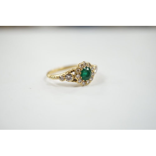 1940 - A Victorian style yellow metal emerald and diamond set circular cluster ring, with graduated diamond... 