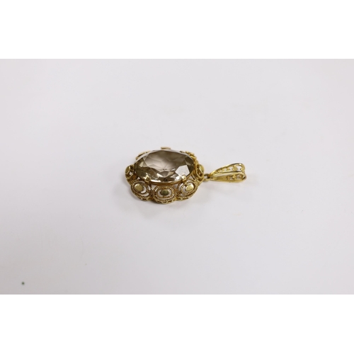 1946 - A 9ct gold and single stone oval cut pale smoky quartz set pendant, 50mm, gross weight 12.7 grams.... 