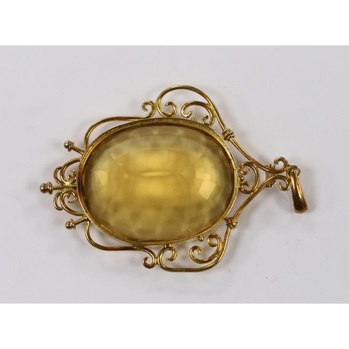 1953 - A yellow metal mounted oval cut citrine pendant, overall 56mm, gross weight 15.8 grams.