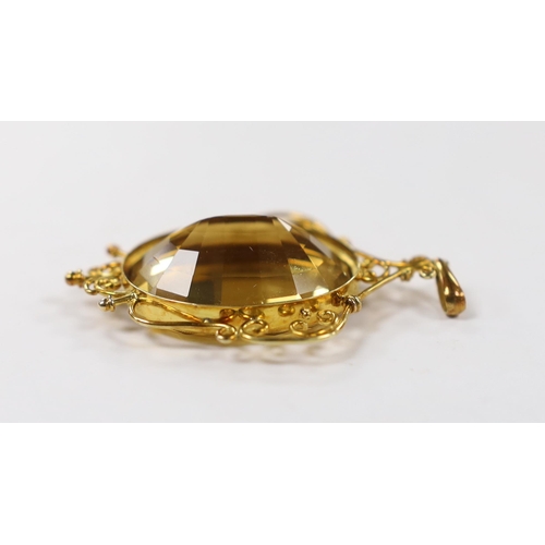 1953 - A yellow metal mounted oval cut citrine pendant, overall 56mm, gross weight 15.8 grams.