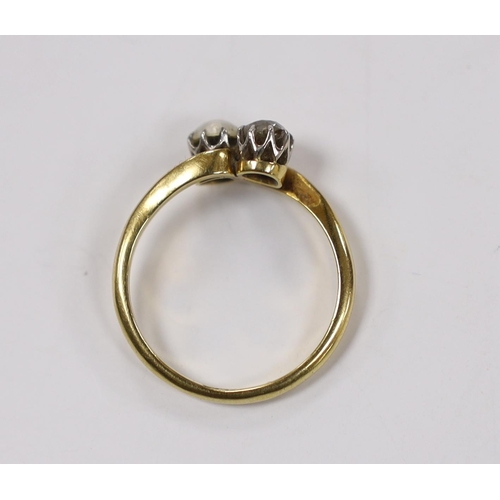 1964 - An 18ct, single stone diamond and single stone cultured pearl set crossover ring, size L/M, gross we... 