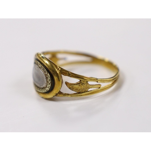 1965 - An early 19th century two colour yellow metal mourning ring, with glazed panel and pierced foliate s... 