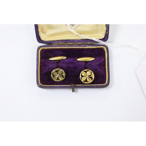 1977 - A pair of continental yellow metal overlaid circular cufflinks, of pierced foliate form, 14mm.... 