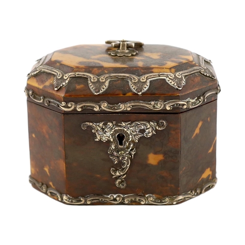 29 - A Victorian silver mounted blond tortoiseshell tea caddy of octagonal form with loop handle and scro... 