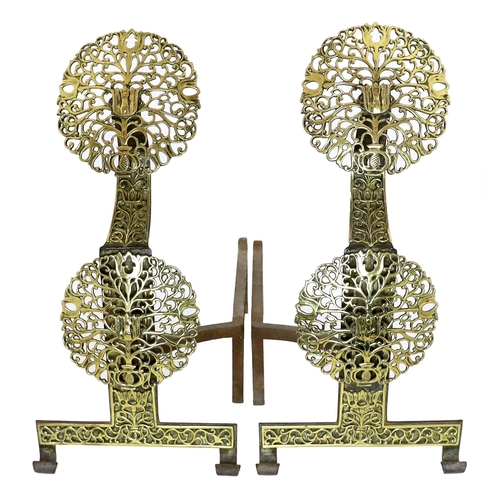 31 - A pair of Arts & Crafts cast iron and pierced brass firedogs, in the manner of Edward Spencer and th... 