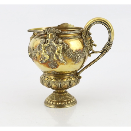 356 - An early Victorian ornate silver gilt cream jug, by George Ivory, decorated with mask, garlands of f... 