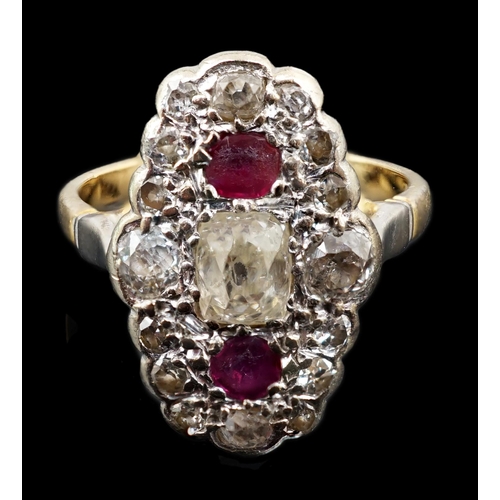 451 - An 18ct gold ruby and diamond cluster ring, the central old mine cut diamond flanked by two rubies a... 