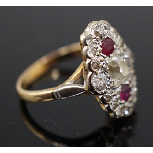 451 - An 18ct gold ruby and diamond cluster ring, the central old mine cut diamond flanked by two rubies a... 