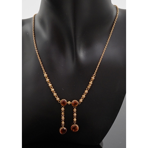 452 - An Edwardian 15ct gold, seed pearl and citrine graduated double drop necklace, set with four round c... 