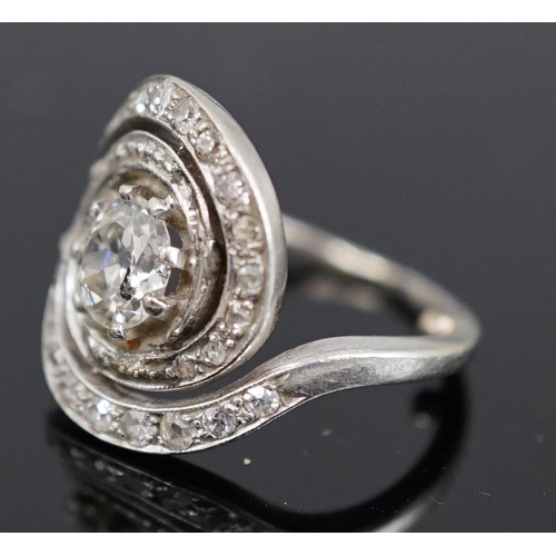 455 - A mid 20th century platinum and diamond cluster set ring, of spiralling design, the central stone me... 