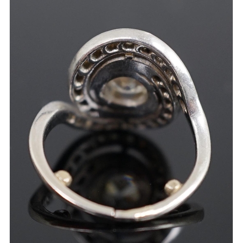 455 - A mid 20th century platinum and diamond cluster set ring, of spiralling design, the central stone me... 