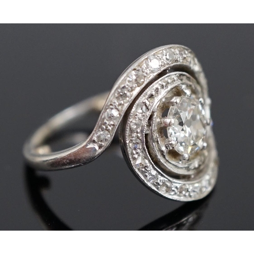 455 - A mid 20th century platinum and diamond cluster set ring, of spiralling design, the central stone me... 