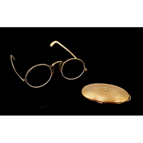 456 - A pair of engraved gold mounted spectacles, with double hinged arms, unmarked, arm length 11.1cm, wi... 