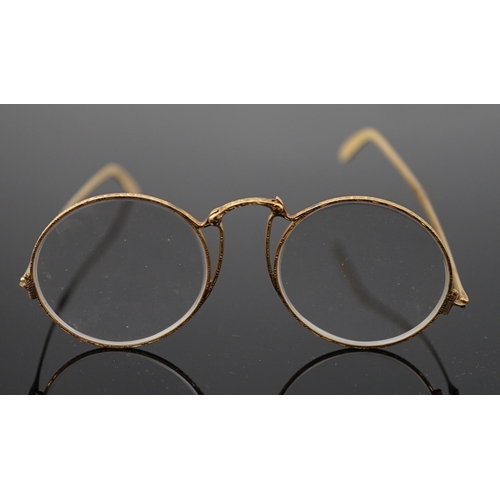 456 - A pair of engraved gold mounted spectacles, with double hinged arms, unmarked, arm length 11.1cm, wi... 