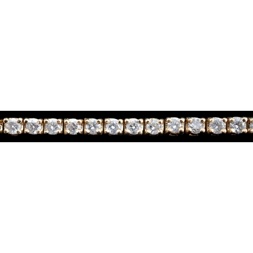 458 - A modern 18ct gold and fifty nine stone round brilliant cut diamond set line bracelet, the stones ap... 