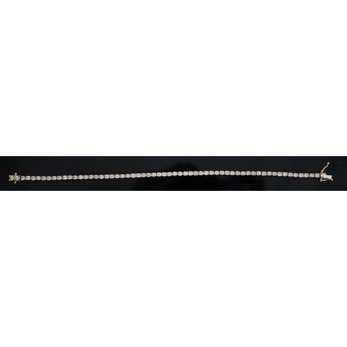 458 - A modern 18ct gold and fifty nine stone round brilliant cut diamond set line bracelet, the stones ap... 