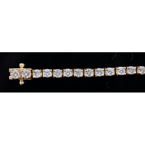 458 - A modern 18ct gold and fifty nine stone round brilliant cut diamond set line bracelet, the stones ap... 