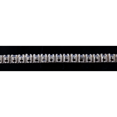 458 - A modern 18ct gold and fifty nine stone round brilliant cut diamond set line bracelet, the stones ap... 