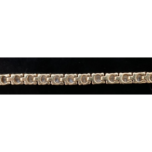 458 - A modern 18ct gold and fifty nine stone round brilliant cut diamond set line bracelet, the stones ap... 